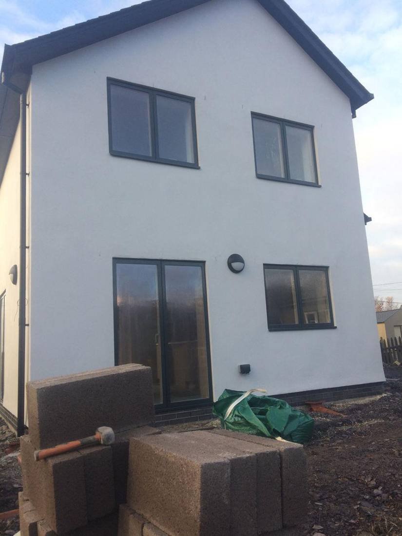 Newly rendered house with patio doors