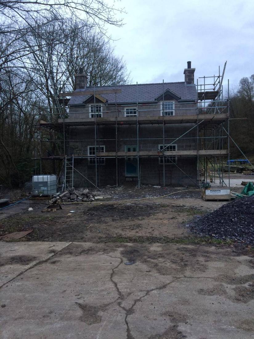 House under scaffolding during building work